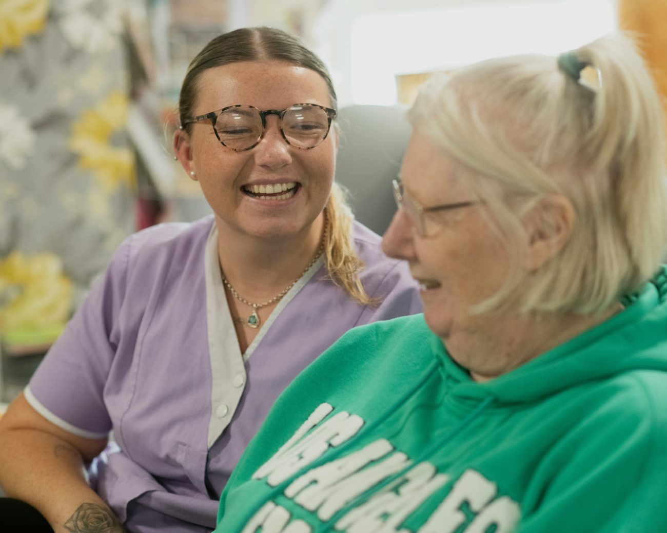 A CareLocate support worker and an older participant sharing a warm moment at home